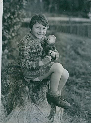 Гроздобер фотографија на сираче девојче, Танија elоел, држејќи кукла, пристигна во Англија од Белсен.